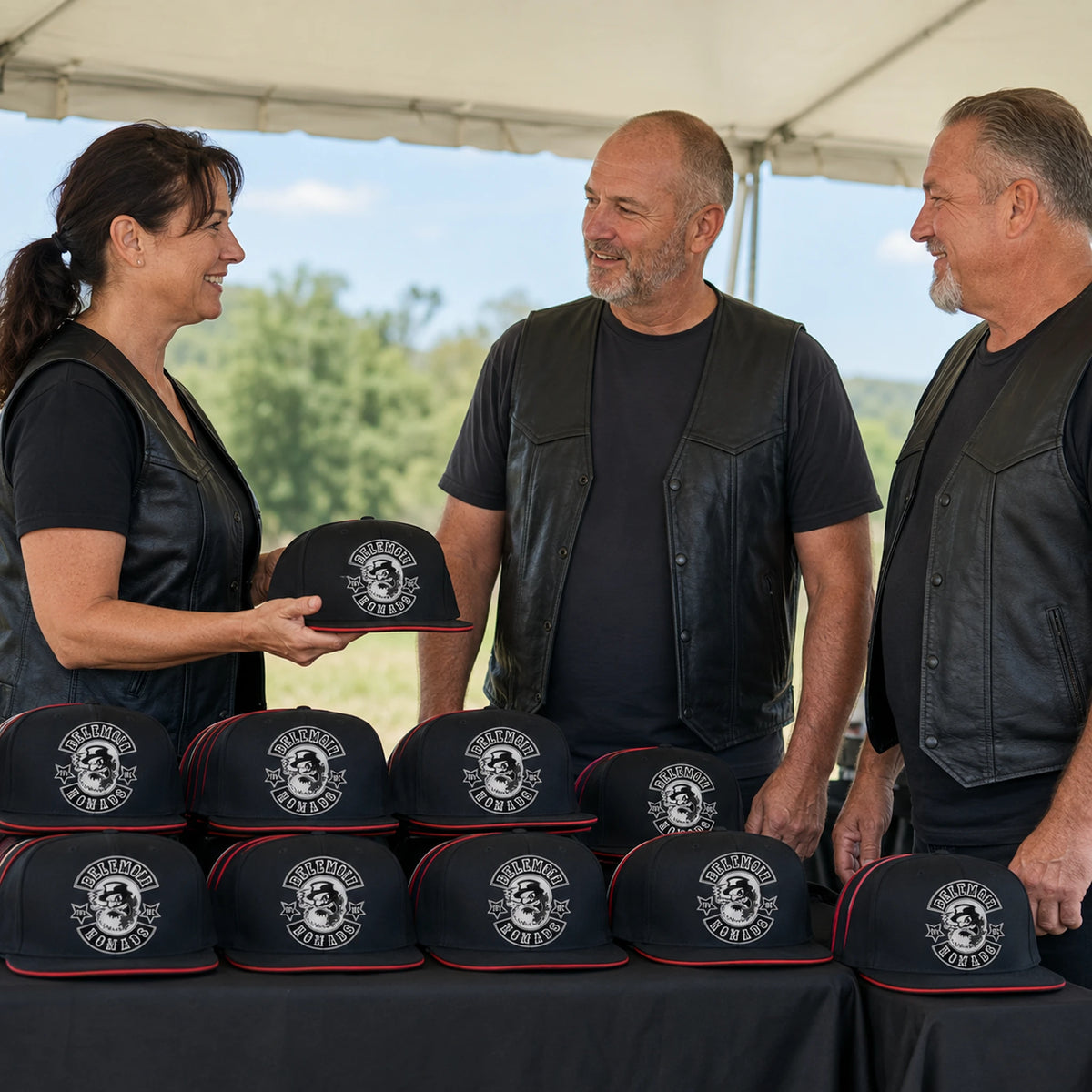 Motorcycle club riders browse custom flat-brim caps at an unbranded open-air rally merchandise tent.