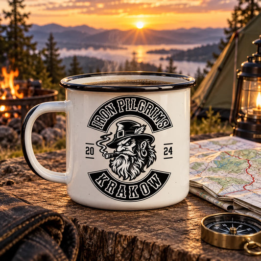 Complete enamel camp mug carrying the club emblem and a restrained rally-year motif, beside a folded route map at a sunrise campsite.