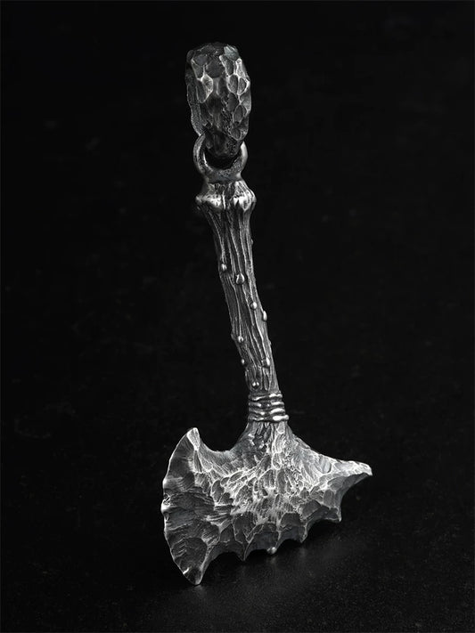 Raw stone axe sterling silver biker pendant on a black background