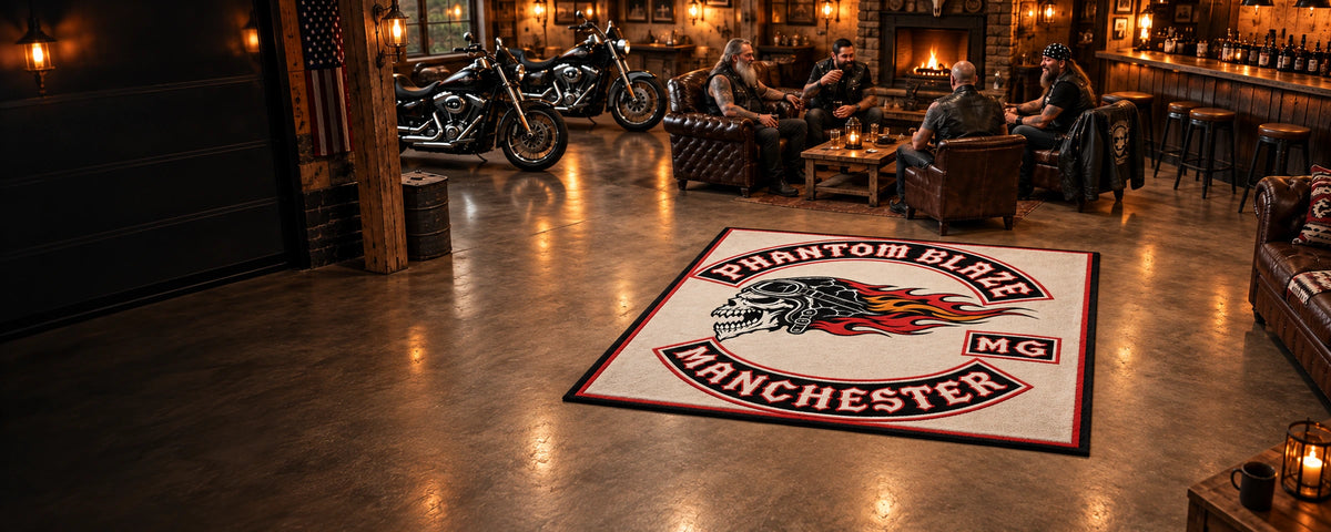 A complete large custom motorcycle club rug is fully visible inside a clubhouse with American V-twin motorcycles.