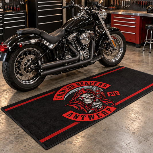 A custom motorcycle garage mat sits beside an American V-twin motorcycle.