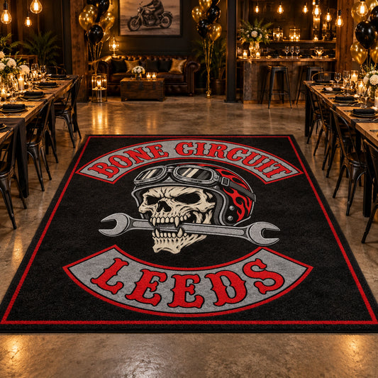 Motorcycle club members gather around a custom anniversary event rug.