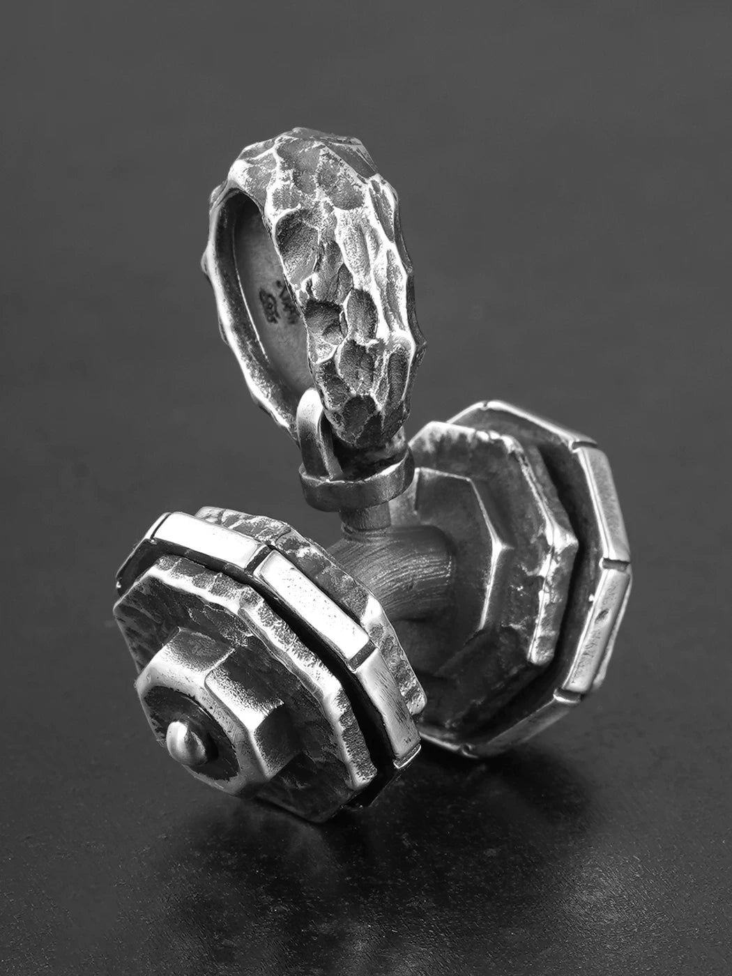 Rotating dumbbell sterling silver biker pendant, angled view