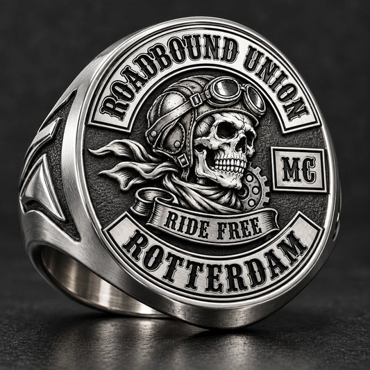 Round stainless steel motorcycle club signet ring with a centered club emblem.