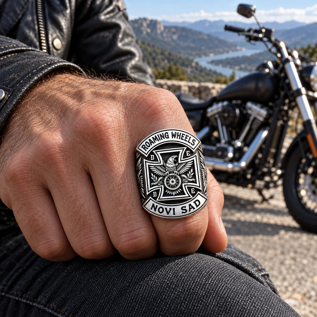 Roaming Wheels club member wearing a custom white copper rally ring beside a parked motorcycle.