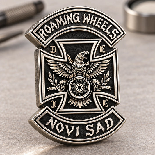 Complete antique silver ROAMING WHEELS club-logo-outline pin with a crisp connected perimeter on a pale workshop surface.