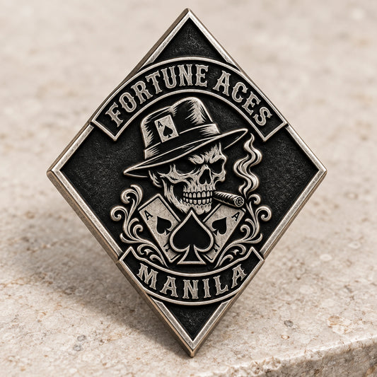 Diamond-shaped antique silver FORTUNE ACES pin with a sculpted skull and four clear outer points on pale stone.