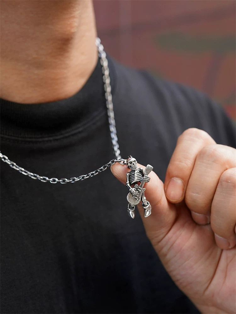Skeleton guitar biker pendant shown worn for scale