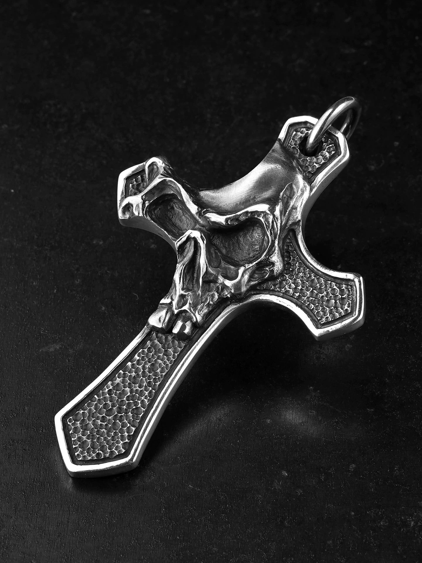 Angled view of skull cross sterling silver motorcycle pendant