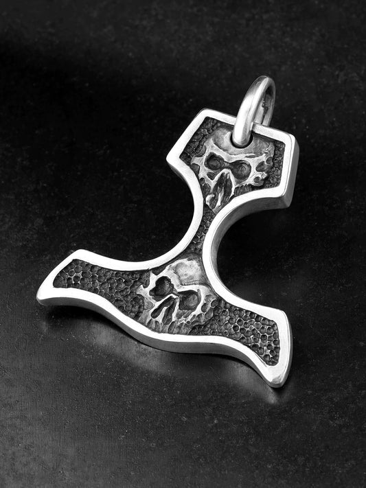Angled view of skull knuckle duster sterling silver biker pendant