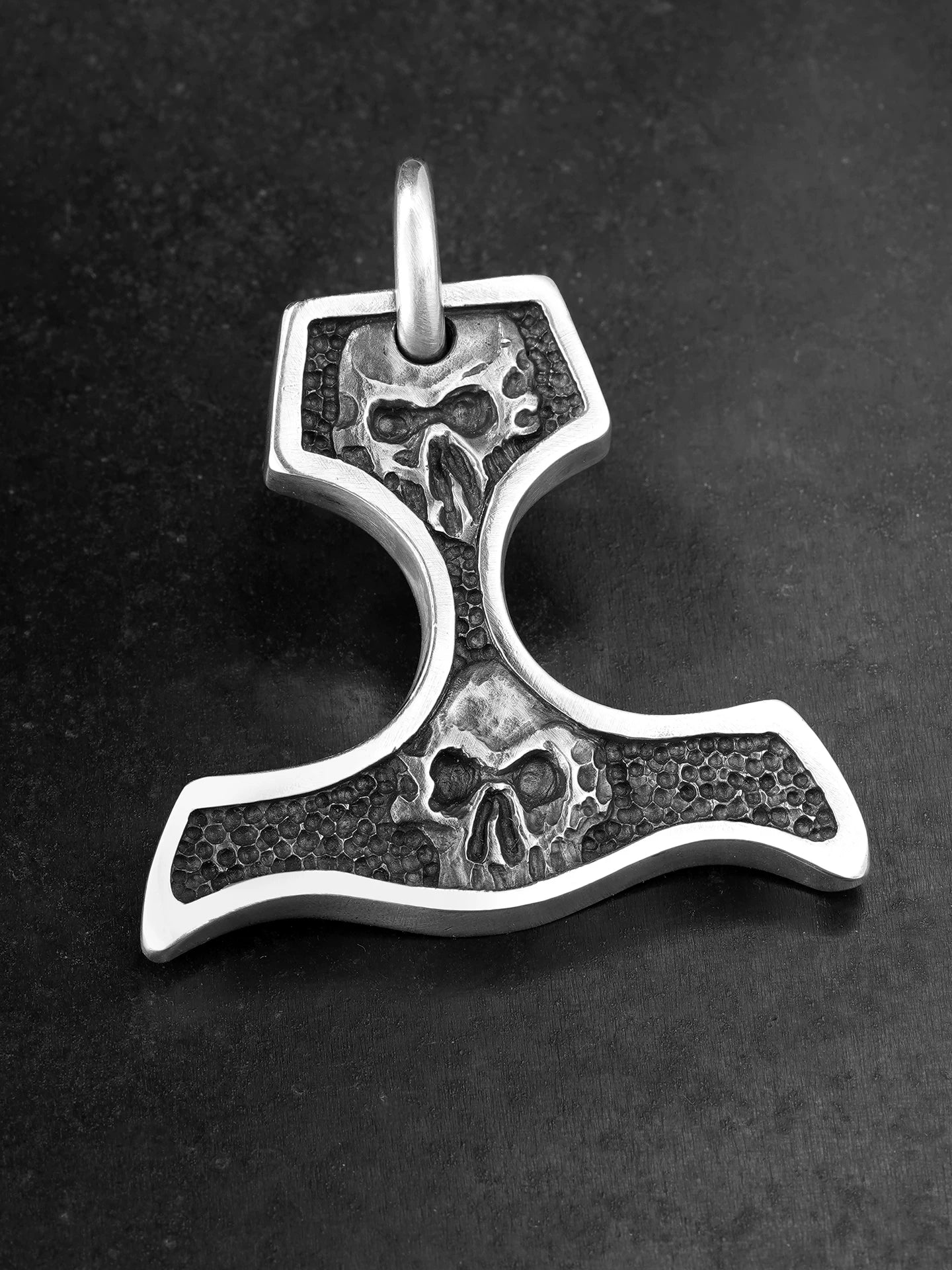 Front view of double skull knuckle duster silver pendant