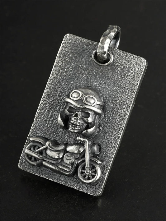 Angled view of handcrafted motorcycle skull silver pendant