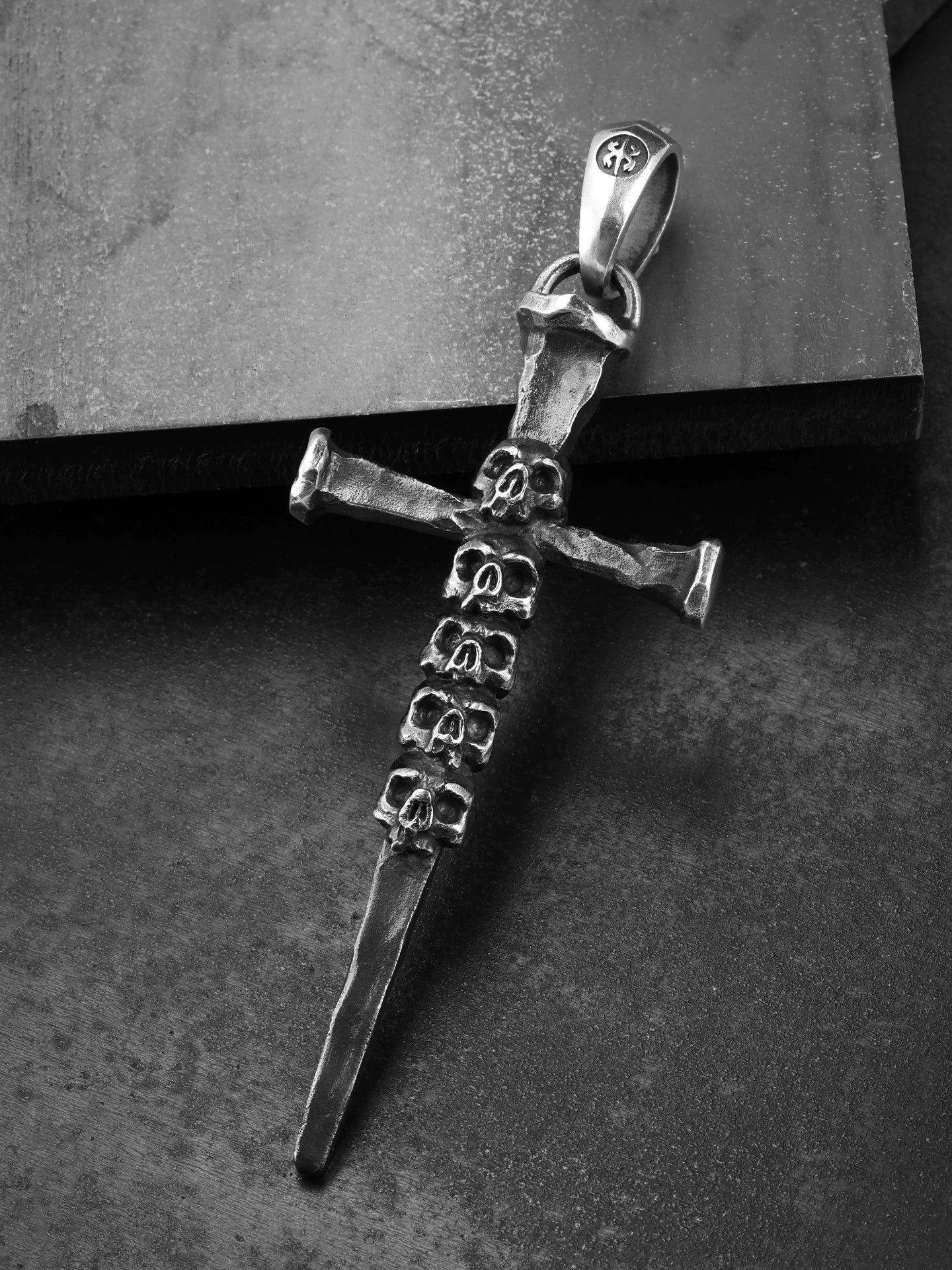 Forged skull sword cross silver pendant angled view