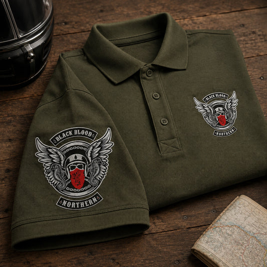 Olive Black Blood Northern polo pieces on a rally table show sleeve embroidery beside a matching left chest emblem.