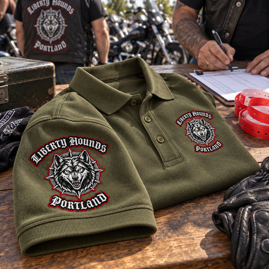Olive Liberty Hounds Portland polo displays a turned embroidered sleeve beside its matching left chest club emblem.