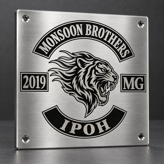 Brushed stainless steel motorcycle club plaque with clean machined edges in a modern workshop.
