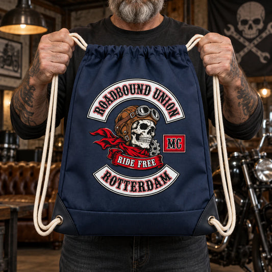 Premium reinforced motorcycle club drawstring backpack displayed in an industrial clubhouse.