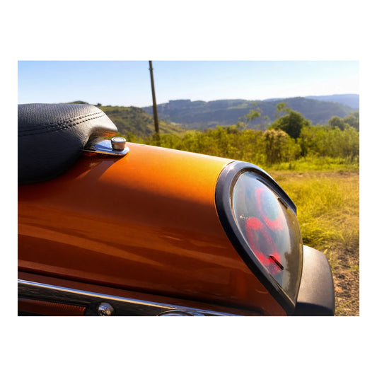 Seat quick-release screw installed on orange motorcycle