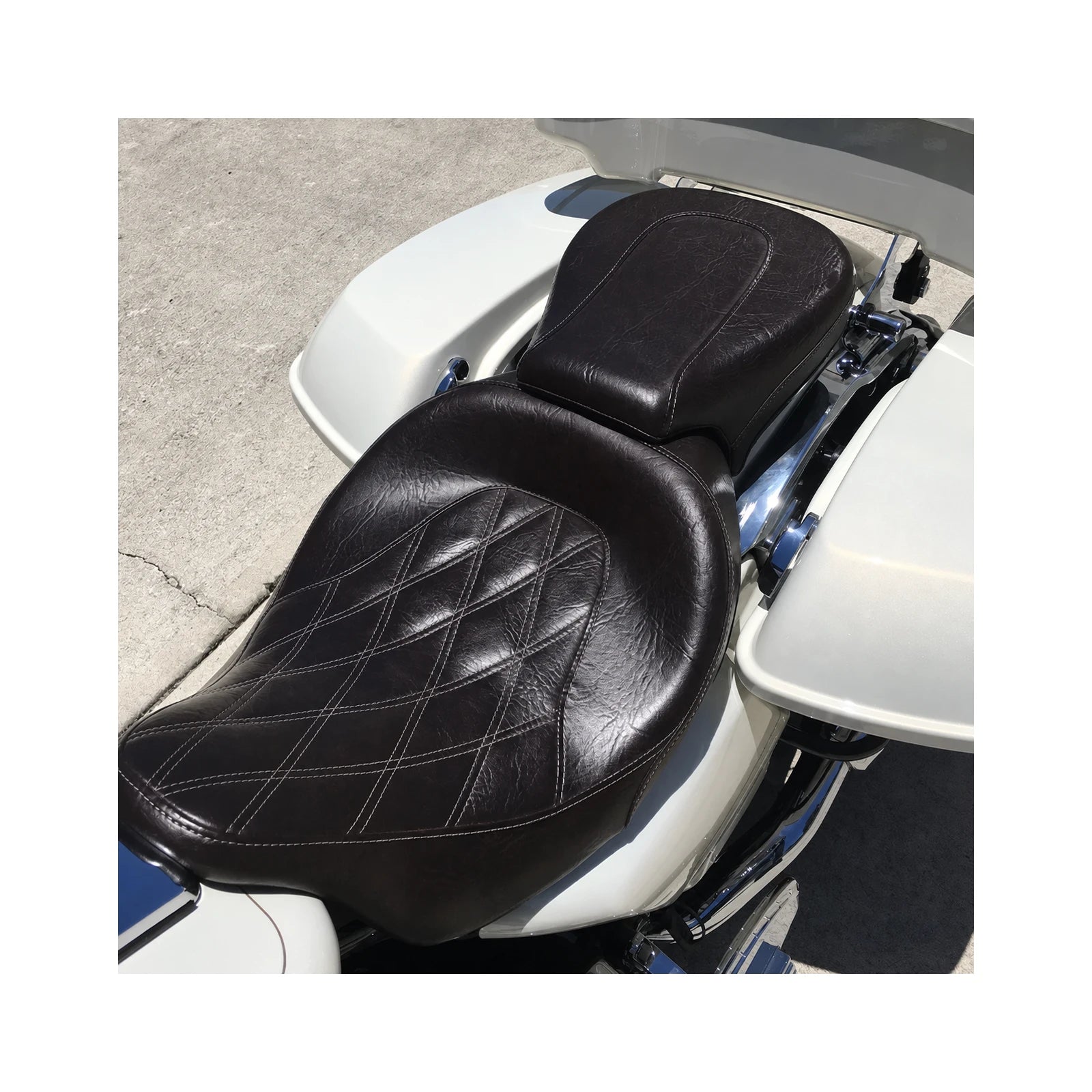 Front and rear motorcycle seats installed on white touring motorcycle