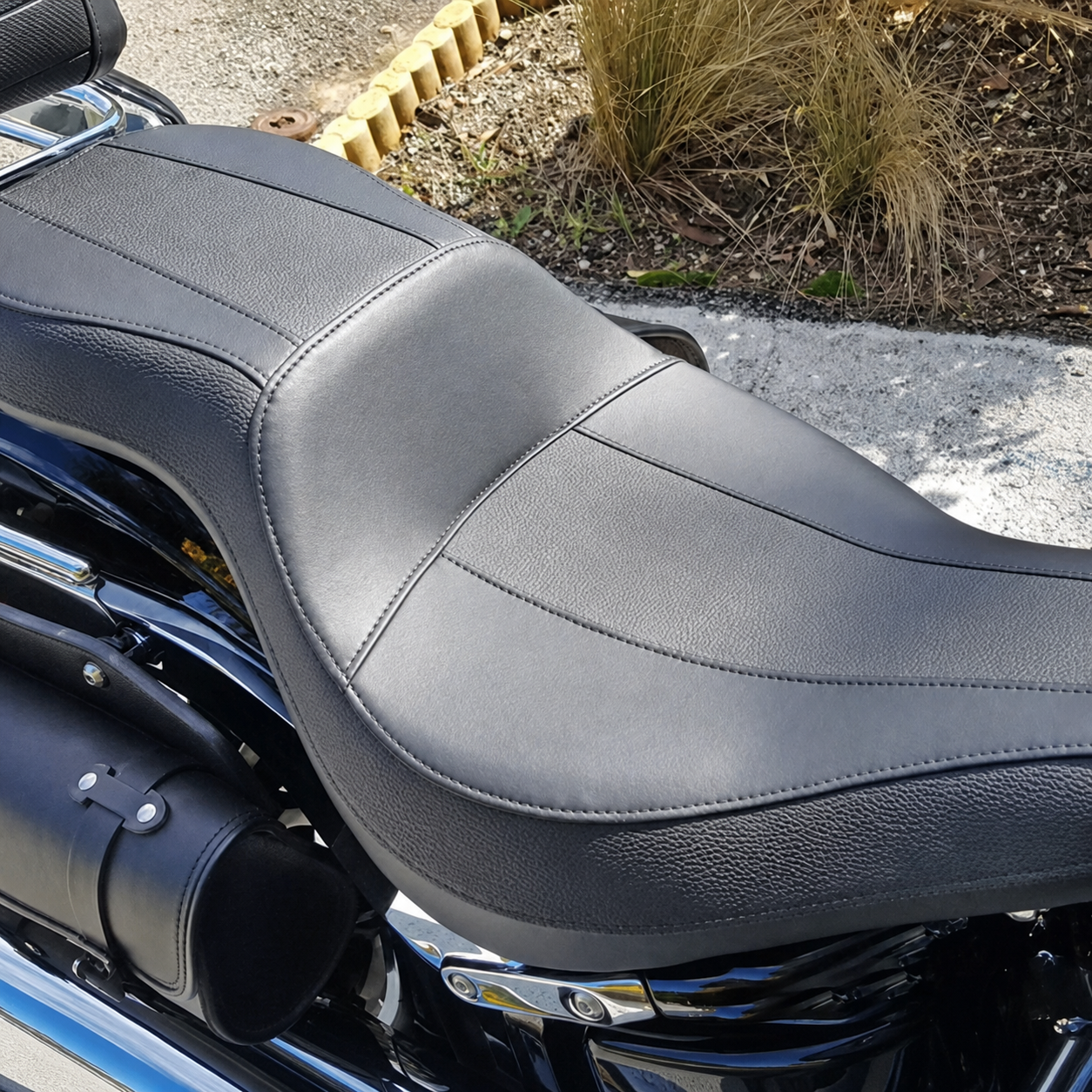 Close-up of low-profile two-up motorcycle seat upholstery and stitching