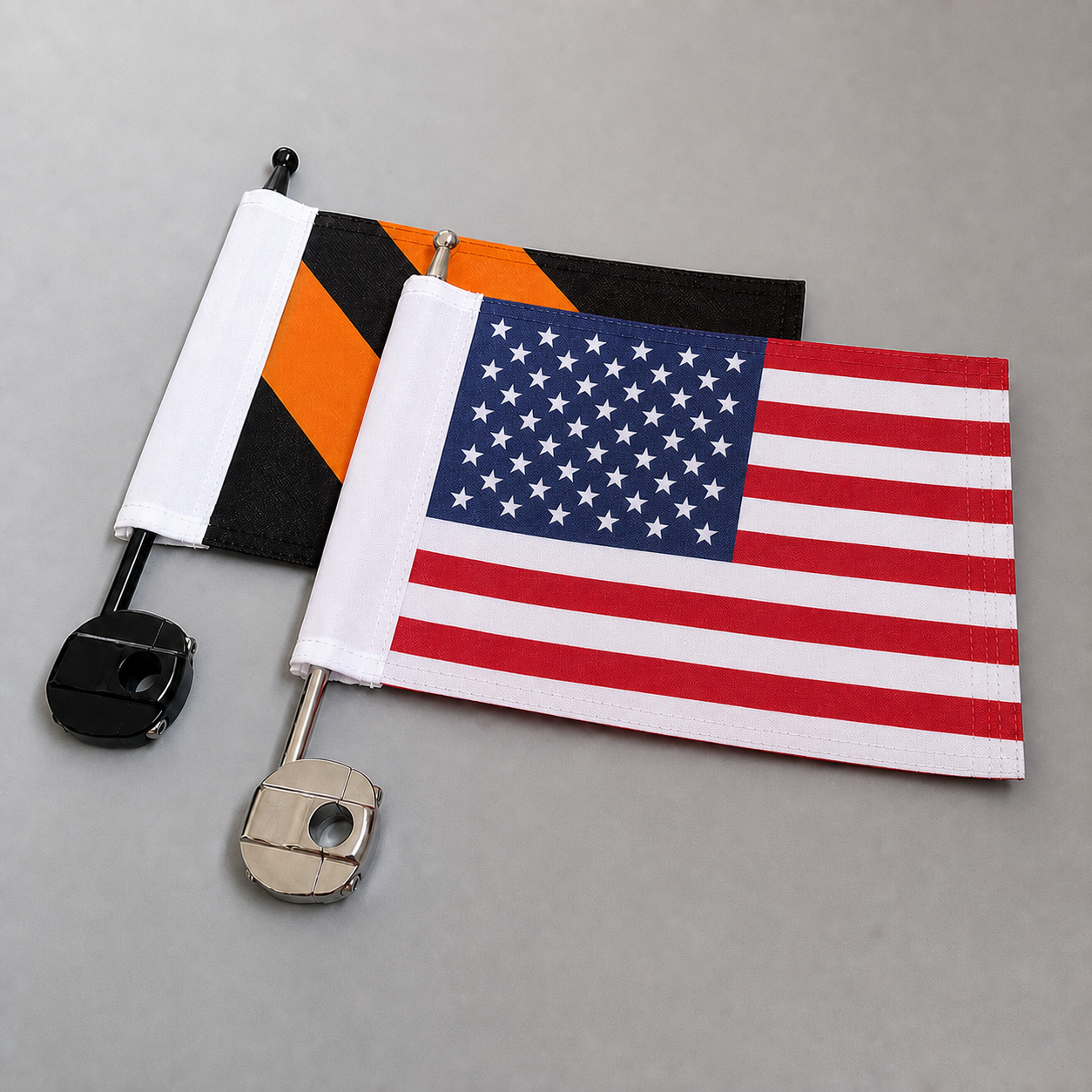 United States flag and black-orange motorcycle flag with luggage-rack poles