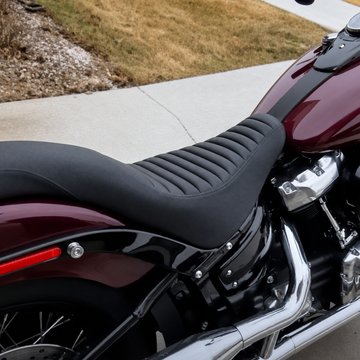 Ribbed two-up seat on burgundy motorcycle