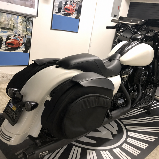 Narrow touring seat installed on motorcycle indoors