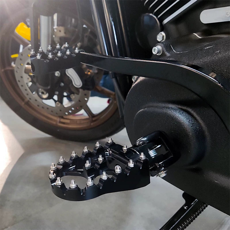 Black CNC foot peg installed on Harley-compatible motorcycle