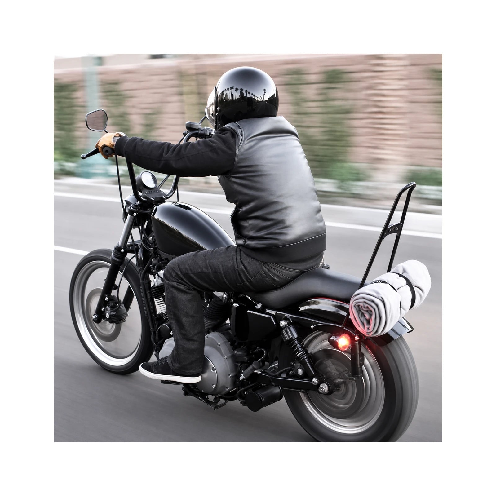 Tall black passenger backrest in riding use