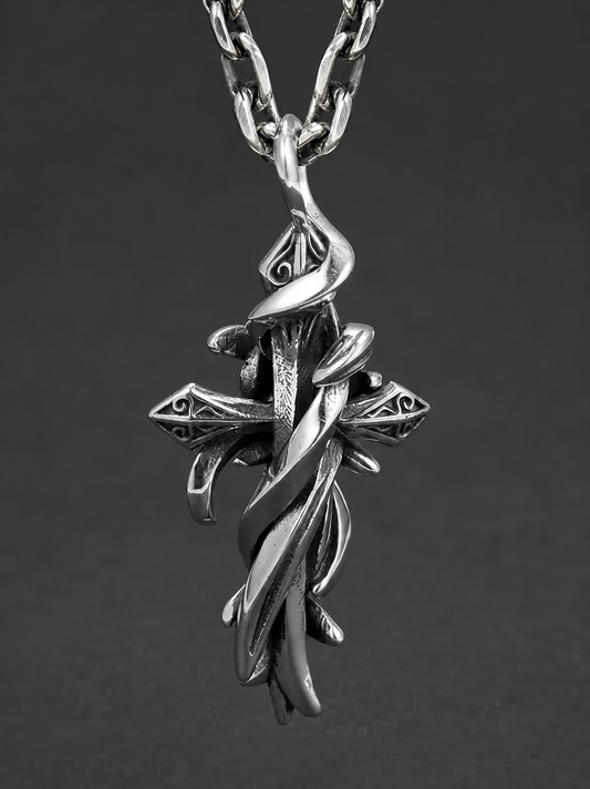 Thorn wrapped vintage cross sterling silver biker pendant on dark background
