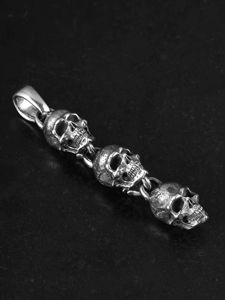 Three linked skulls sterling silver biker pendant angled view