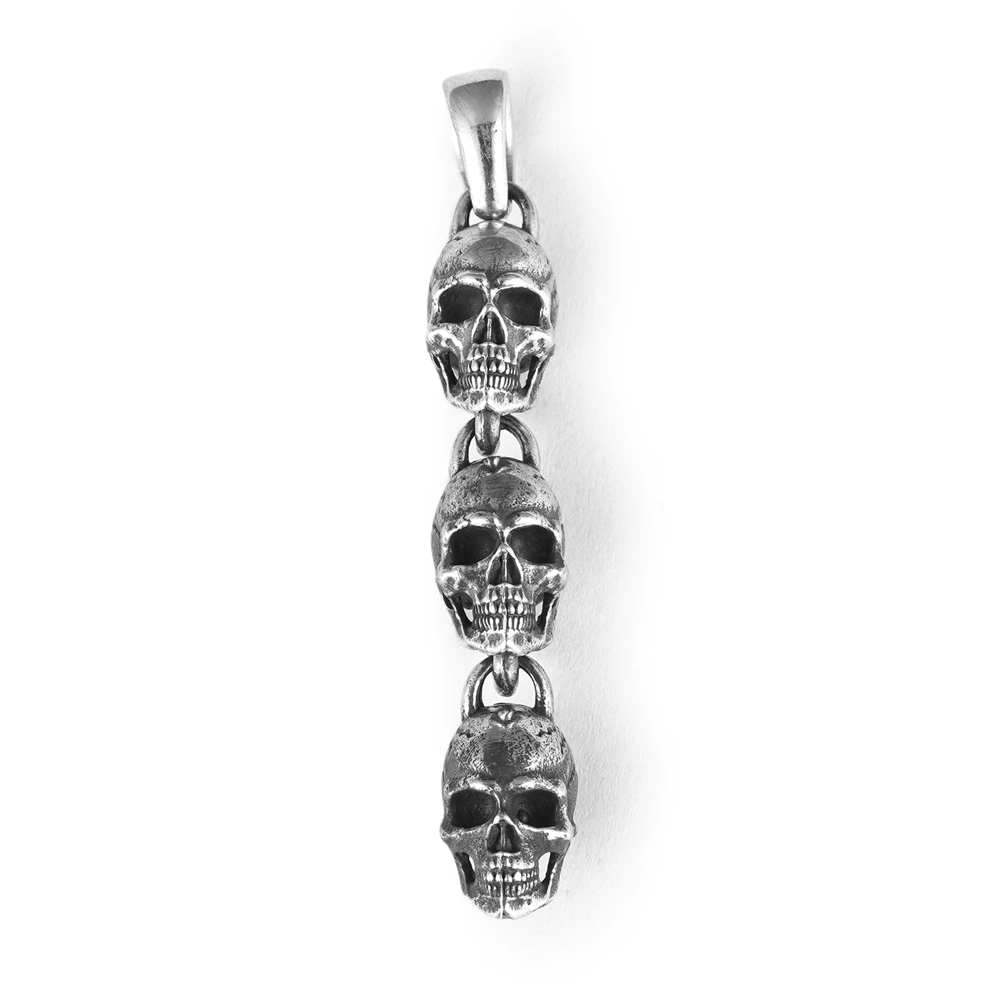 Three linked skulls sterling silver biker pendant isolated on white