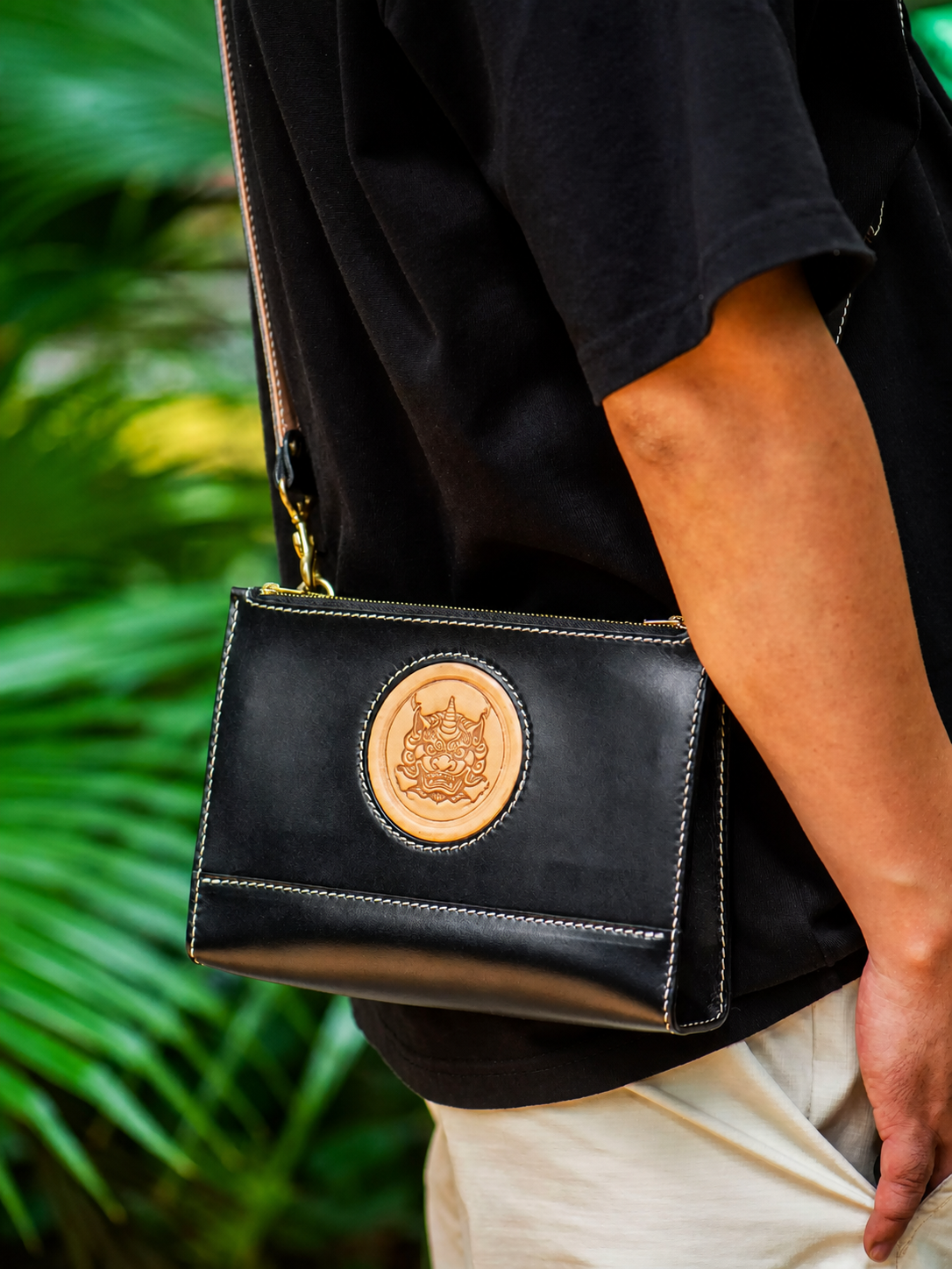 Tianlu Pixiu black leather biker crossbody clutch worn by rider