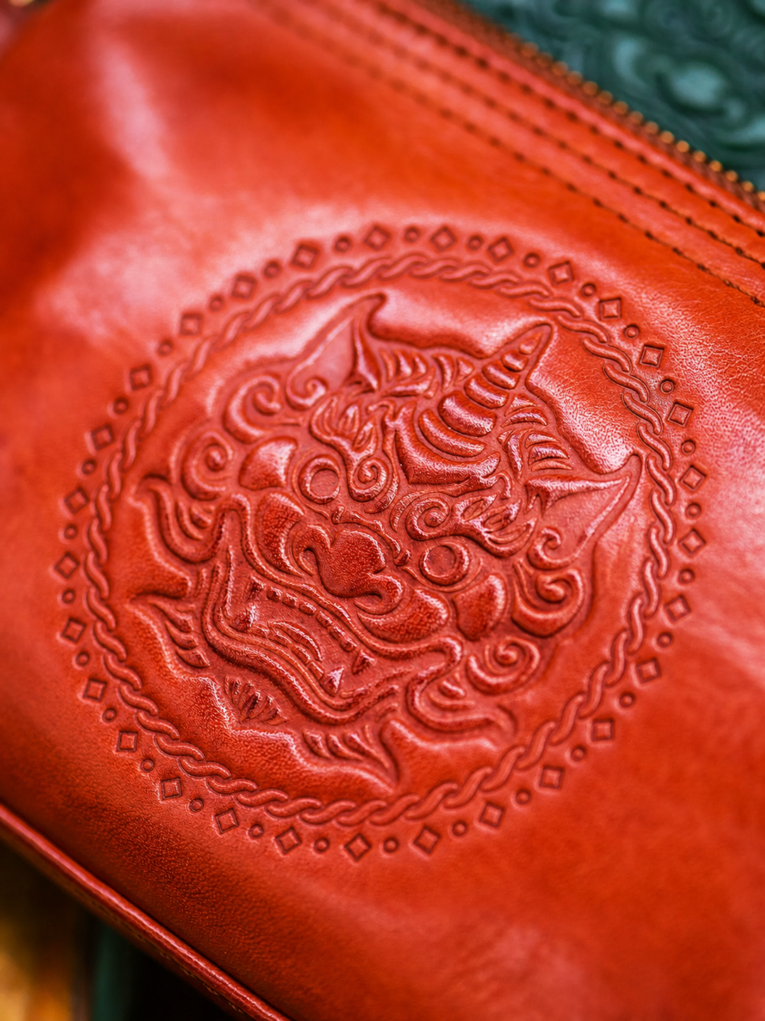 red-brown Tianlu Pixiu leather embossing detail