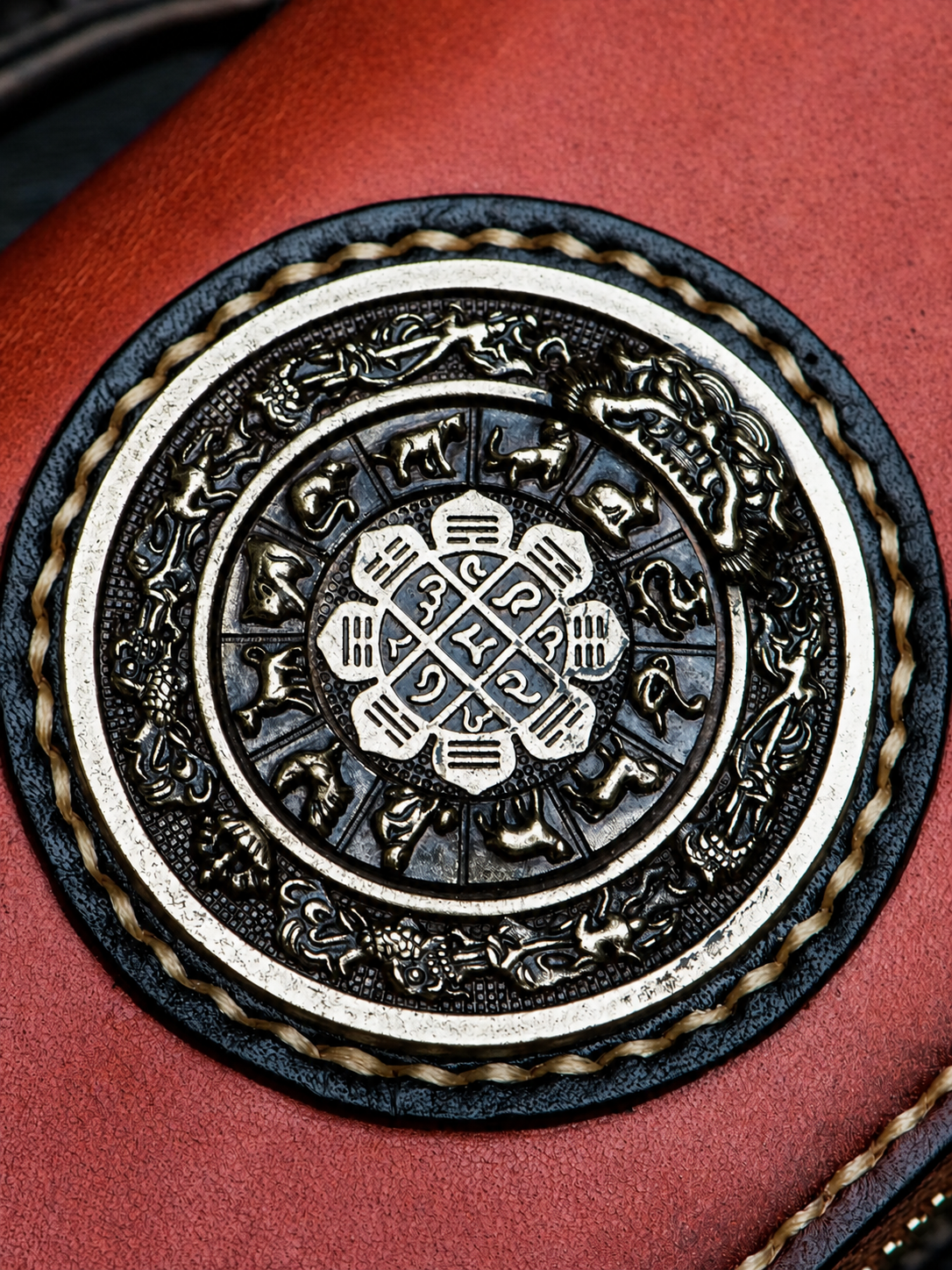 close-up of the solid brass Nine-Palace medallion and hand stitching