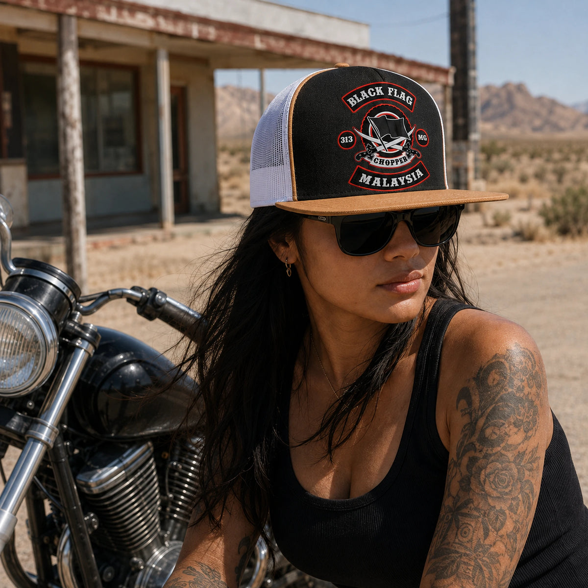 A motorcycle club rider wears a black-and-tan flat-brim trucker cap with breathable mesh panels.