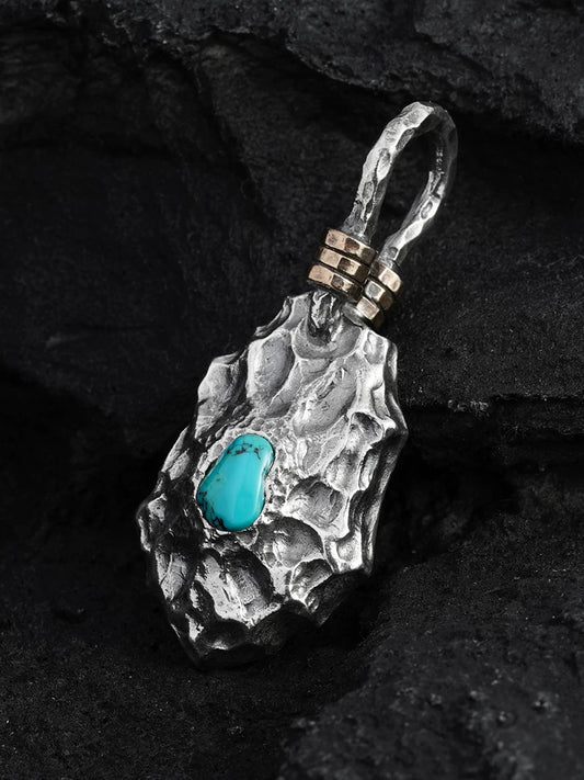 Turquoise dragon-scale shield sterling silver biker pendant, angled view