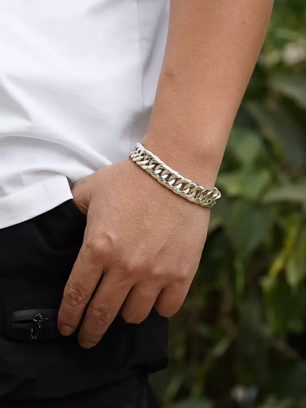 men's polished sterling silver curb bracelet worn on wrist