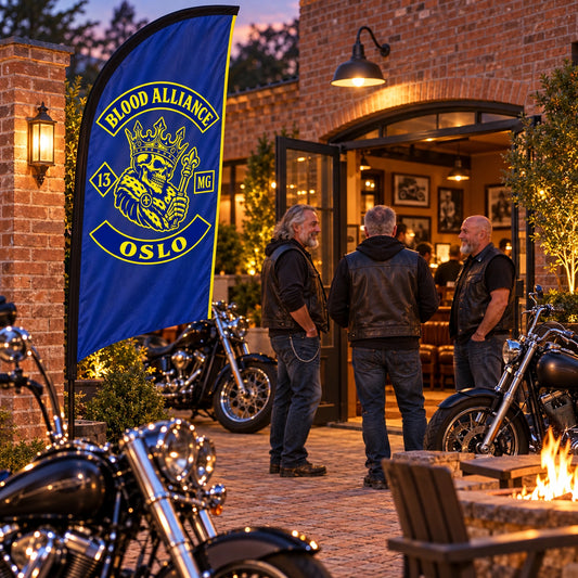 Clubhouse Displays: custom motorcycle club feather flag shown in warm brick clubhouse courtyard during an evening member gathering.