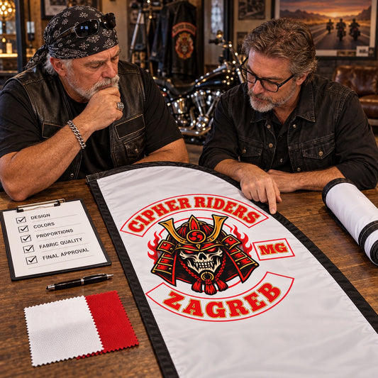 Confirm Final Design: custom motorcycle club feather flag shown in club president and designer carefully reviewing the physical proof together.