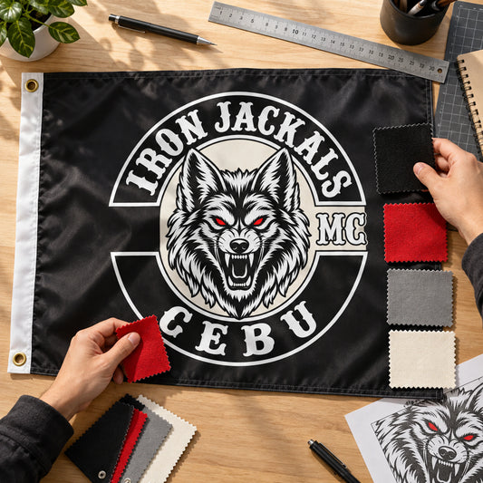 Designer matching color swatches to custom motorcycle club exchange-flag artwork.