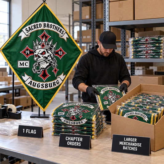 A packer prepares one display flag and a neatly stacked motorcycle club chapter order of matching custom diamond flags.