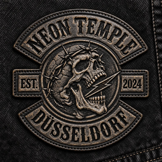 Motorcycle club embossed and debossed leather anniversary patch featuring the authorized Neon Temple Dusseldorf identity in a black denim product studio.