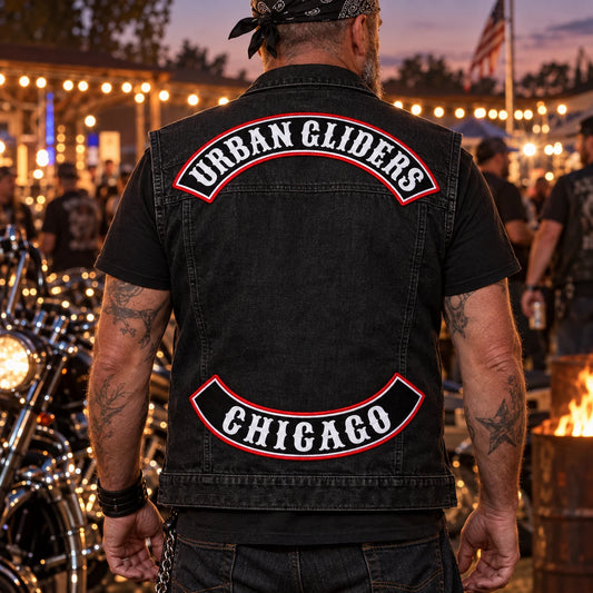 Motorcycle club rider wearing anniversary-edition top and bottom rocker patches at an evening rally.