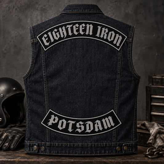 Complete dark indigo denim motorcycle vest displaying a custom club typeface on coordinated top and bottom rockers.