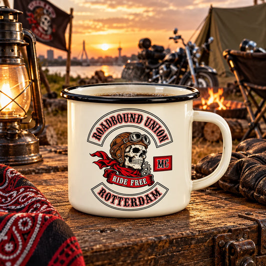 Complete cream steel-core enamel camp mug with black rolled rim and club emblem, staged at a rugged rally campsite.
