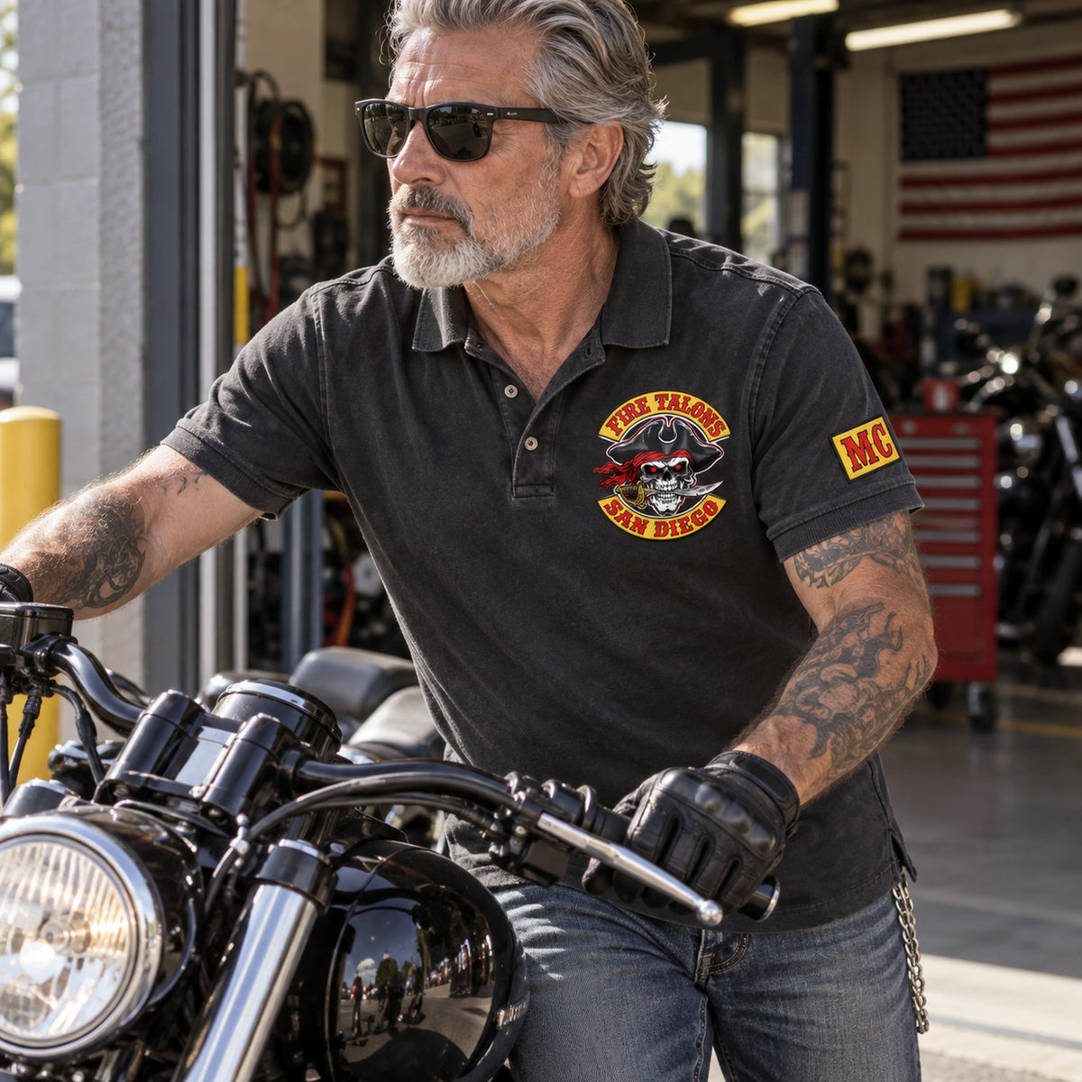 A Fire Talons San Diego member wears a washed-black club polo with visible faded texture, chest emblem and sleeve embroidery.
