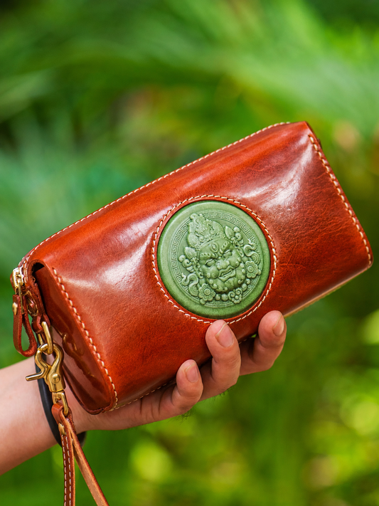 reddish brown wealth guardian leather biker clutch wallet held in hand