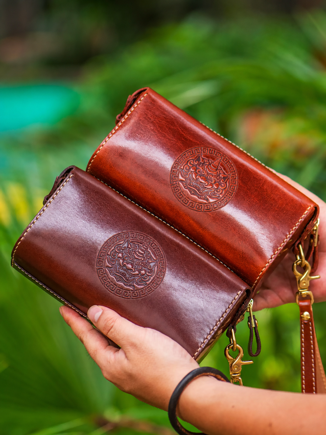 decorative embossed backs of two wealth guardian leather biker wallets