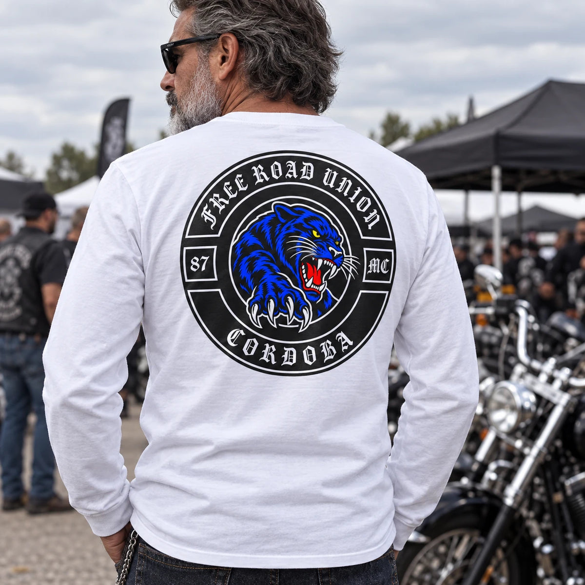 White motorcycle club long-sleeve shirt with clear fabric detail at an outdoor rally.